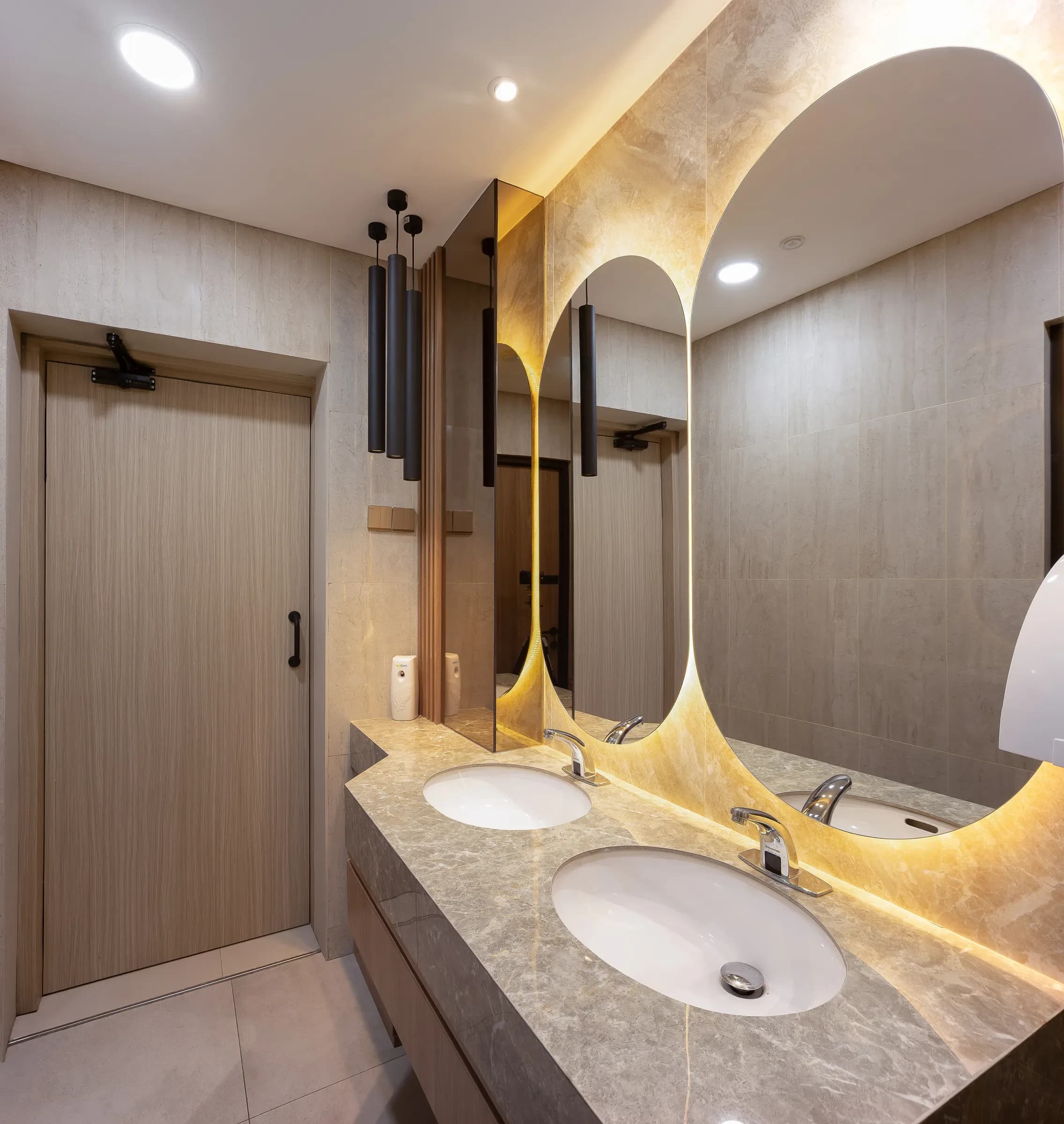 Washroom with an arched backlit mirror