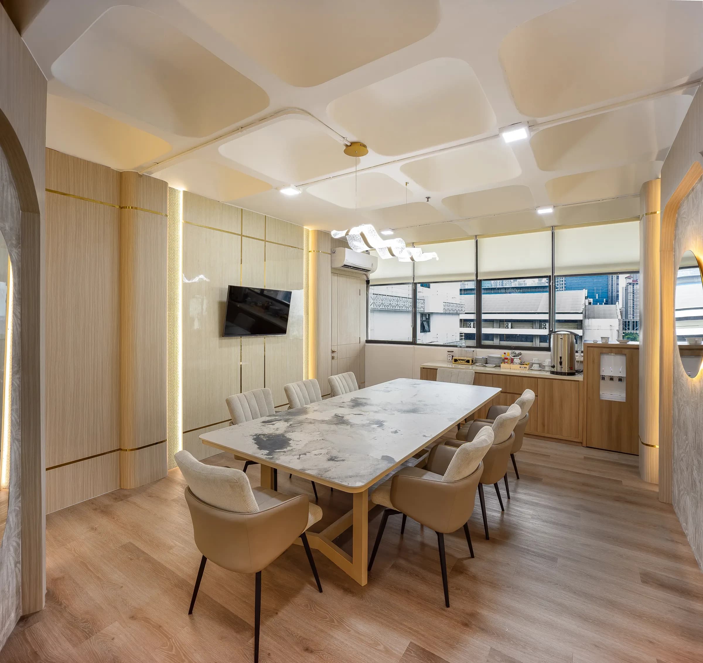 Meeting room with a marble table and a round backlit mirror