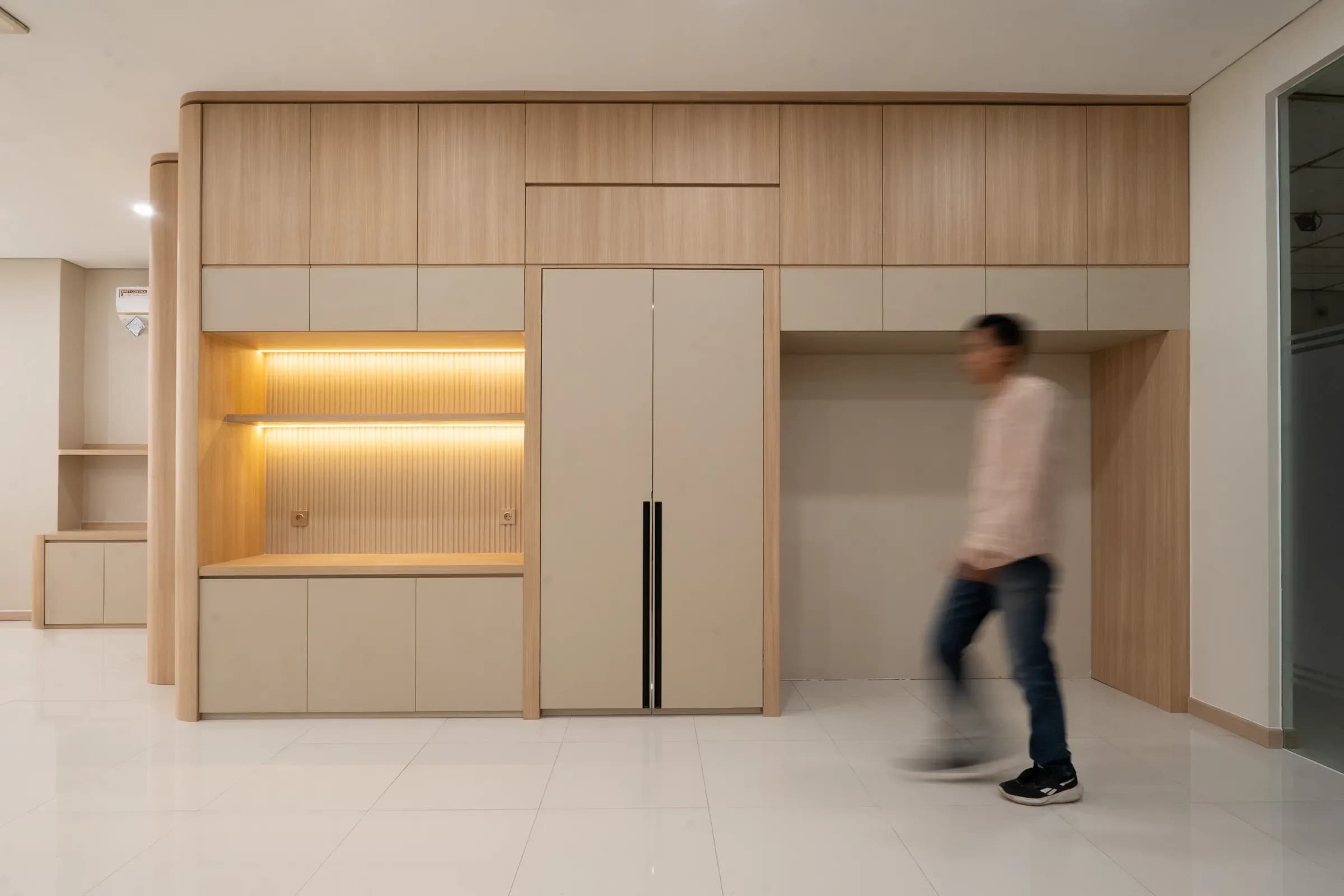 Built-in wood cabinetry along a corridor