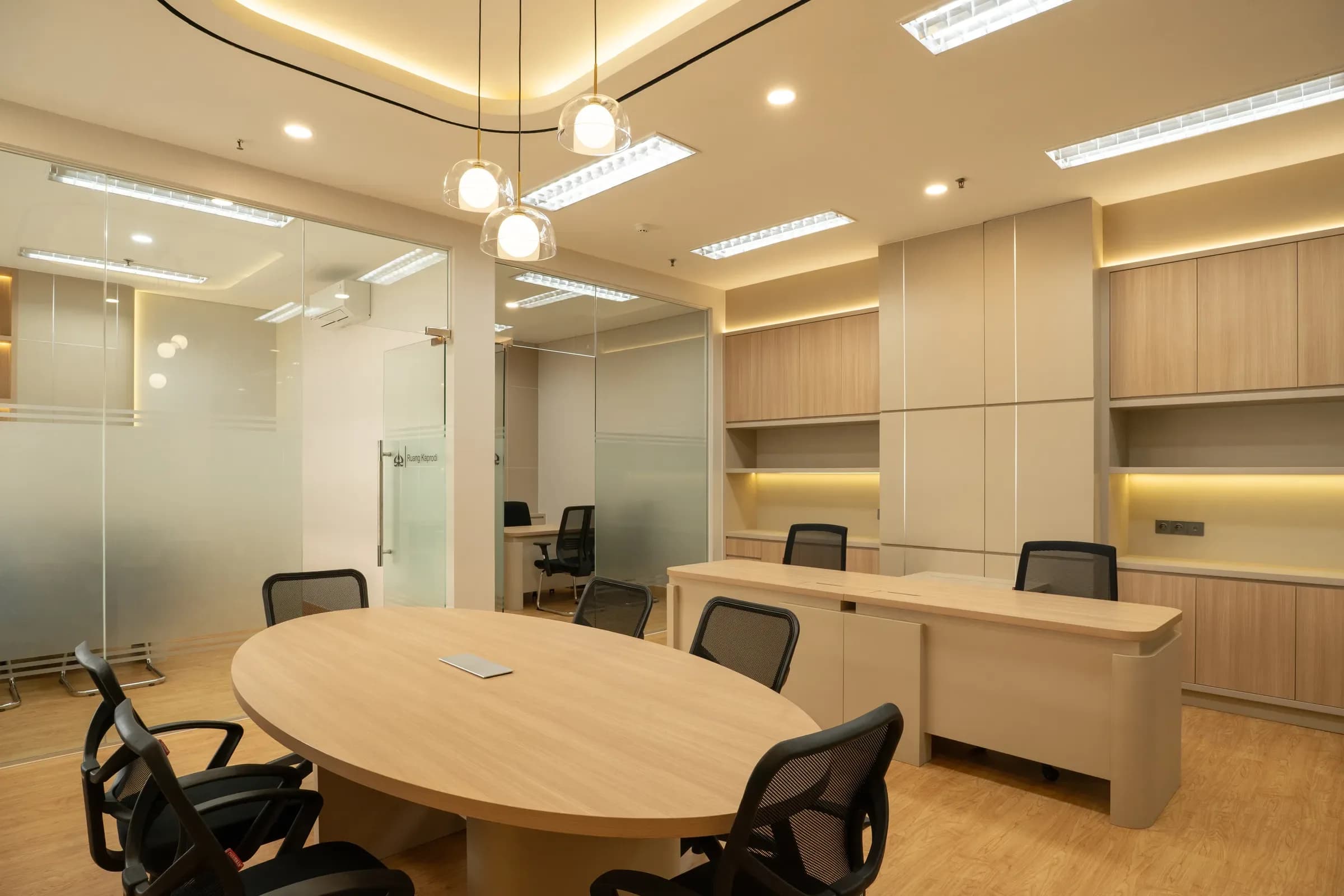 Office with a round meeting table and built-in storage