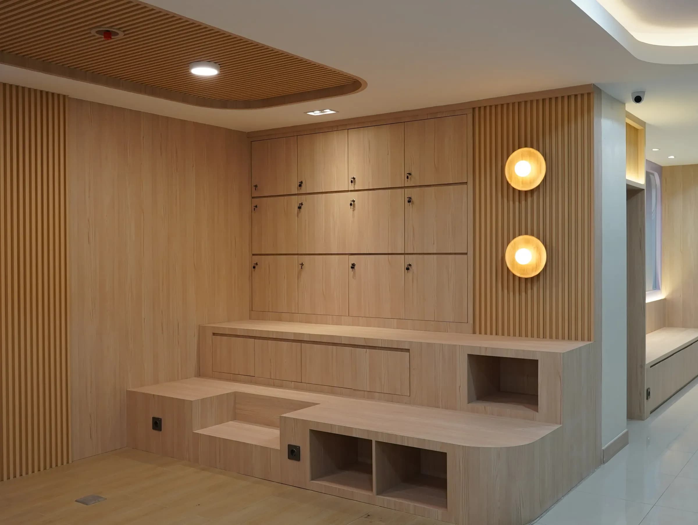 Wood-panelled room with a built-in bench and wall lights