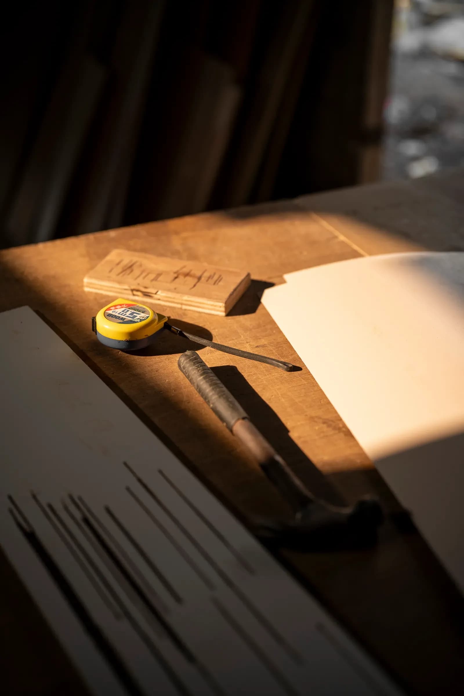 Measuring tape and pencil on a timber board