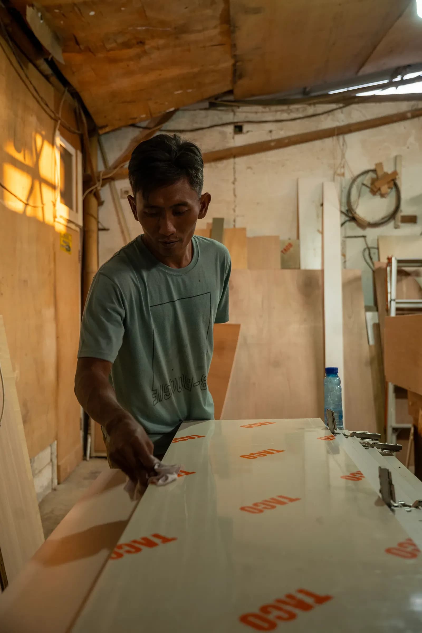 Craftsman working on a panel in the workshop